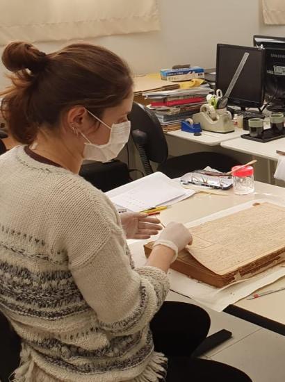 Conservators at Historical Museum of Japanese Immigration working on Burajiru Jiho newspapers