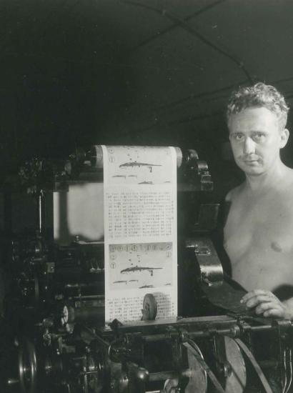 Two men operating a print press at the Office of War Information