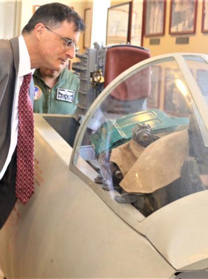 Eric Wakin looking into the cockpit of a plane on display in the American Footprint Museum