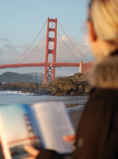 Californian reading a book near the Golden Gate Bridge
