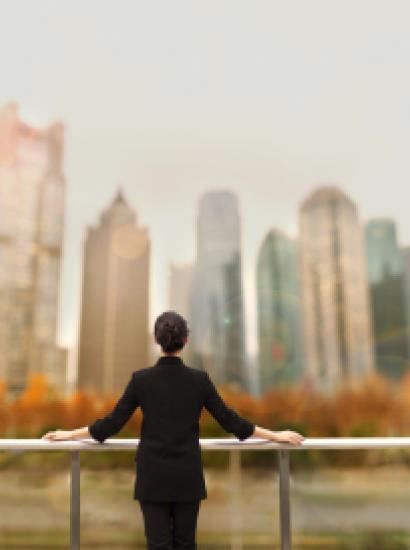 Young woman standing with view of buildings in city downtown