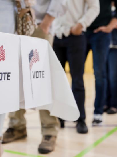 Low angle view of people lined up to vote stock photo