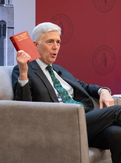 US Supreme Court Justice Neil Gorsuch holds up a copy of Herbert Hoover’s The Challenge to Liberty while speaking at the Hoover Institution’s Winter Board of Overseers meeting on February 24, 2025. 
