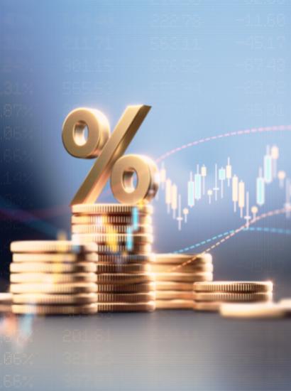 Percentage Sign On Top Of Coin Stacks Before Blue Financial Graph stock photo