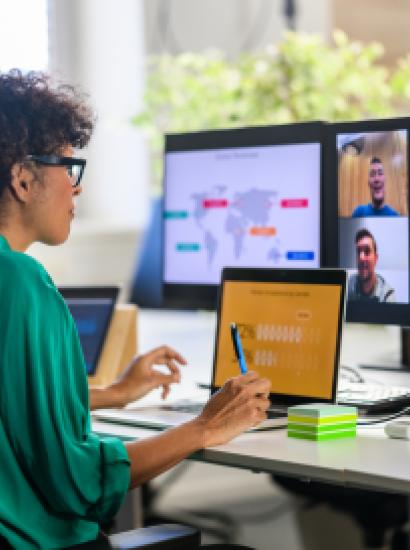 Woman discussing report with remote workers stock photo