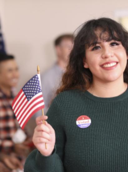 Young adult, Latin descent woman votes in USA election. - stock photo