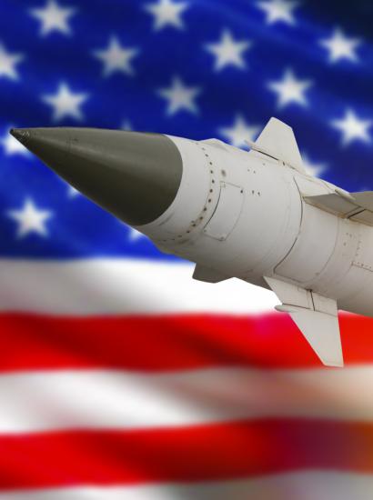 Rocket with a warhead against the background of the flag of the United States of America stock photo
