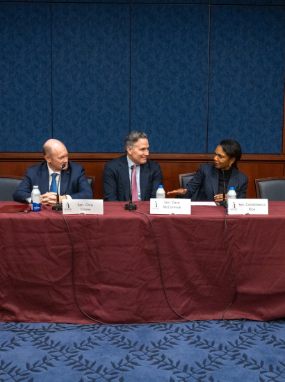 Director Rice, Senators Coons, and McCormick in conversation during their panel session.