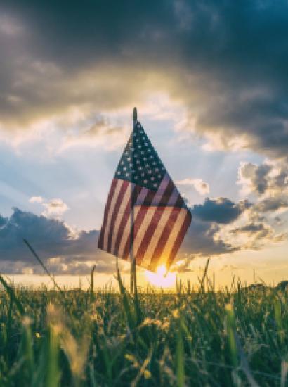 American Flag flying over a field