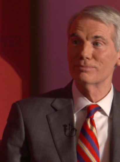 Image of Senator Rob Portman in front an orange-red background