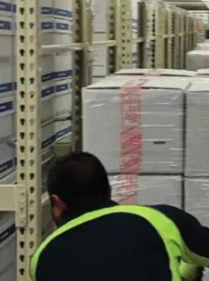 Photograph of boxed archival materials being moved