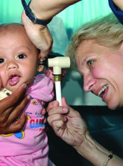 Ronda Bouwens examines a baby