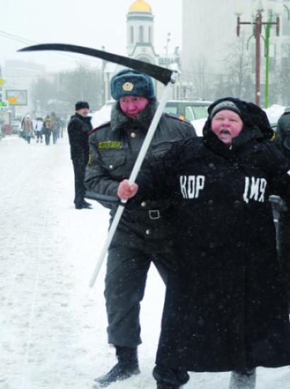 Moscow police officer detains a demonstrator