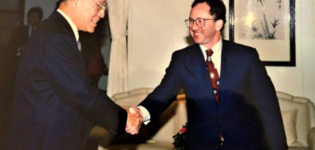 Two men wearing suits shaking hands