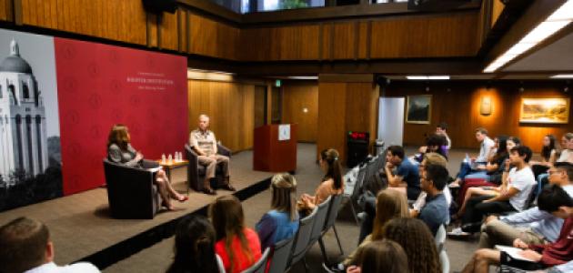 Amy Zegart (left) and General Paul Nakasone in a fireside chat at the Hoover Institution with an audience of Stanford University students.