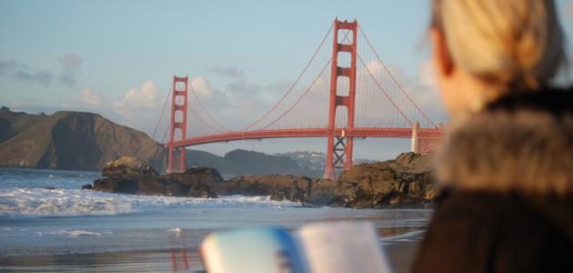 Californian reading a book near the Golden Gate Bridge