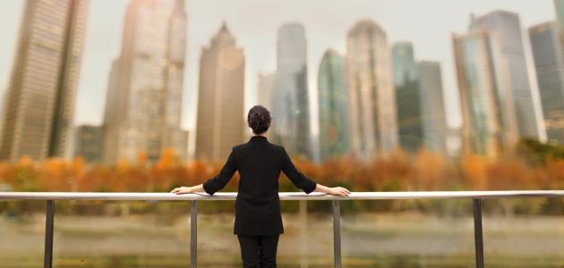 Young woman standing with view of buildings in city downtown