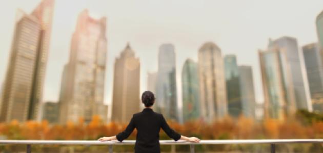 Young woman standing with view of buildings in city downtown