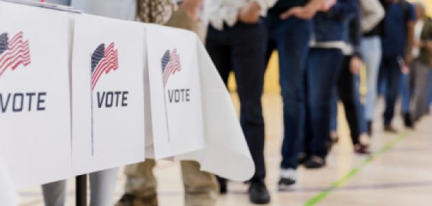 Low angle view of people lined up to vote stock photo