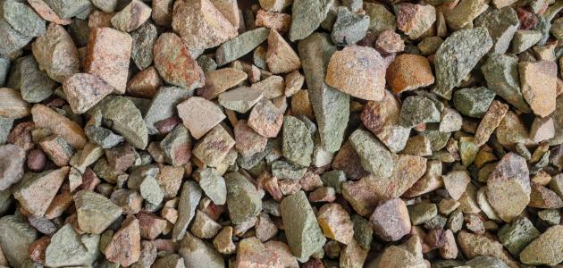 Rare earth (earths) element ore. Critical minerals, used in production of permanent magnets, aerospace alloys, specialty glass, electronic equipment, electric motors of hybrid and electric vehicles (EV), wind turbine generators. Background concept. - stock photo