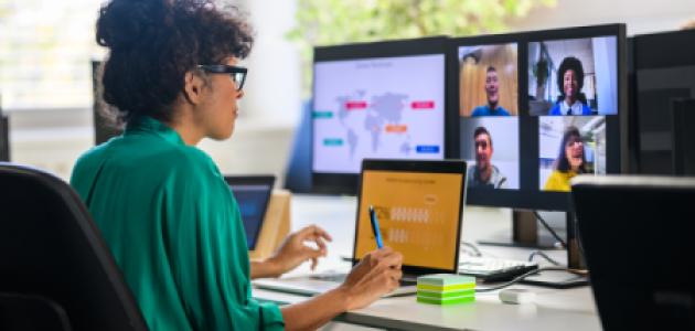 Woman discussing report with remote workers stock photo