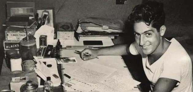 Nat Bellantoni writting a letter at his desk in a tent during World War II