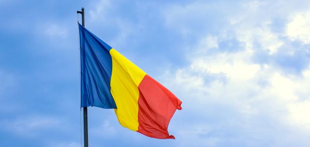Romanian national flag against romantic sky in Bucharest, Romania - stock photo