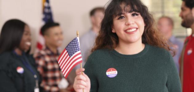 Young adult, Latin descent woman votes in USA election. - stock photo