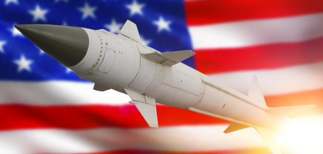 Rocket with a warhead against the background of the flag of the United States of America stock photo