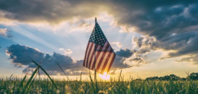 American Flag flying over a field