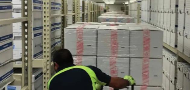 Photograph of boxed archival materials being moved