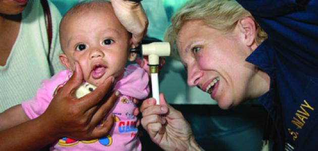 Ronda Bouwens examines a baby