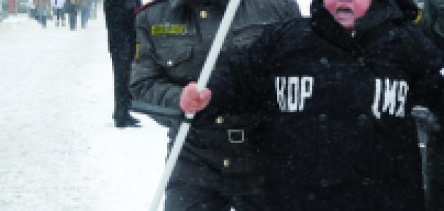 Moscow police officer detains a demonstrator