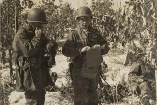 Rasula - sepia toned photo of 2 soldiers in the field