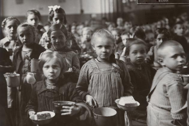 Black and white photograph of children receiving food at an American Relief Administration kitchen in Vienna