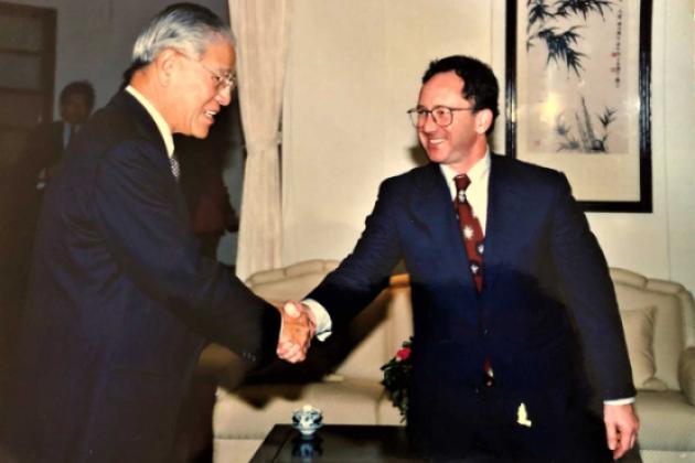 Two men wearing suits shaking hands