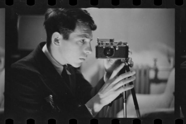 Buchman taking a self-portrait with his camera. Digitized black and white photo negative.
