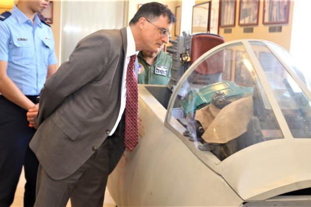 Eric Wakin looking into the cockpit of a plane on display in the American Footprint Museum