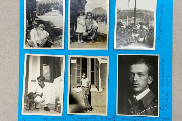 Six black and white photographs adhered to blue paper.
