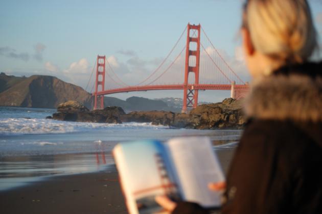 Californian reading a book near the Golden Gate Bridge