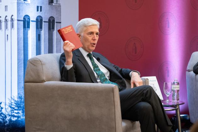 US Supreme Court Justice Neil Gorsuch holds up a copy of Herbert Hoover’s The Challenge to Liberty while speaking at the Hoover Institution’s Winter Board of Overseers meeting on February 24, 2025. 