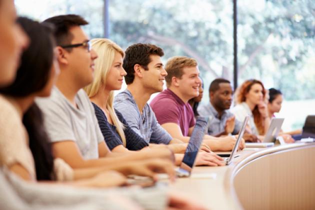 Class Of University Students Using Laptops In Lecture stock photo