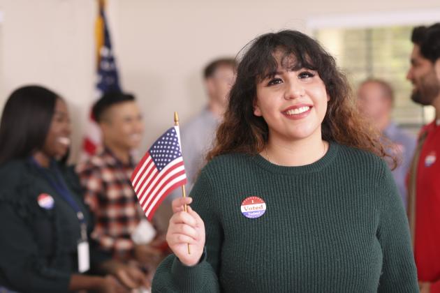 Young adult, Latin descent woman votes in USA election. - stock photo