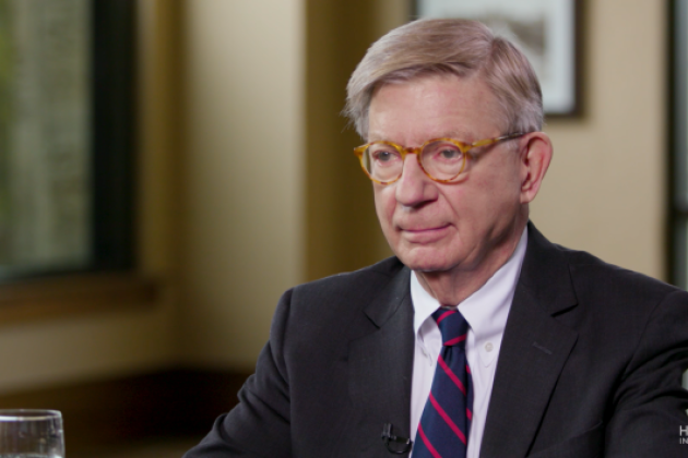 Image of George F. Will sitting at a table.