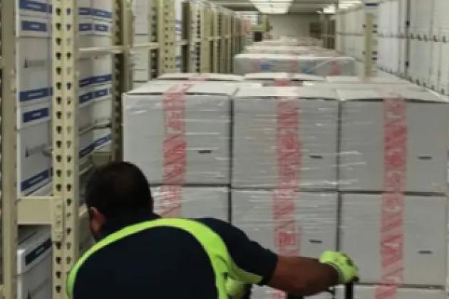 Photograph of boxed archival materials being moved