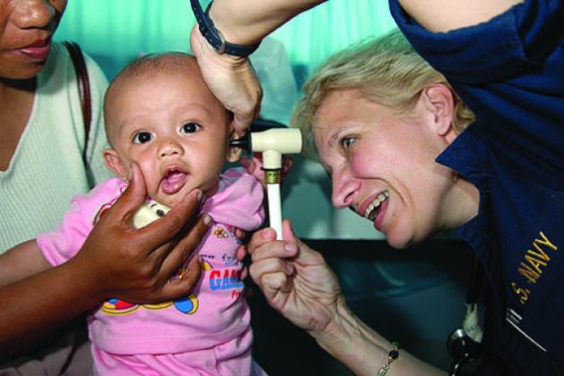 Ronda Bouwens examines a baby