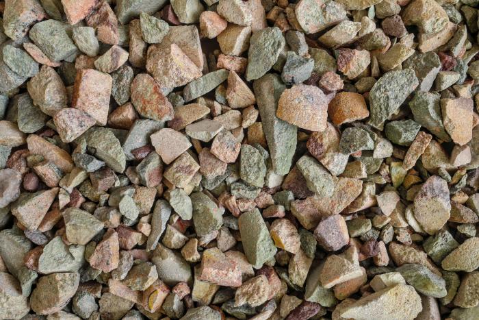 Rare earth (earths) element ore. Critical minerals, used in production of permanent magnets, aerospace alloys, specialty glass, electronic equipment, electric motors of hybrid and electric vehicles (EV), wind turbine generators. Background concept. - stock photo