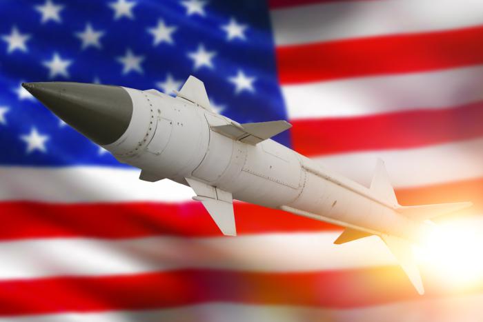 Rocket with a warhead against the background of the flag of the United States of America stock photo