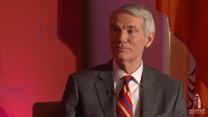 Image of Senator Rob Portman in front an orange-red background