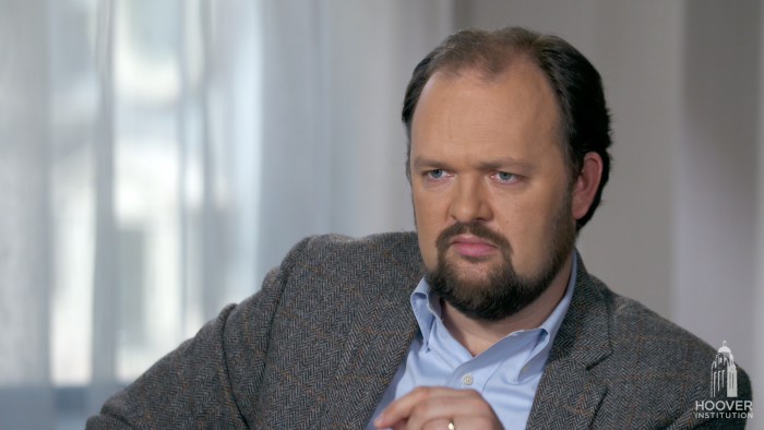 Image of Ross Douthat with a grey background